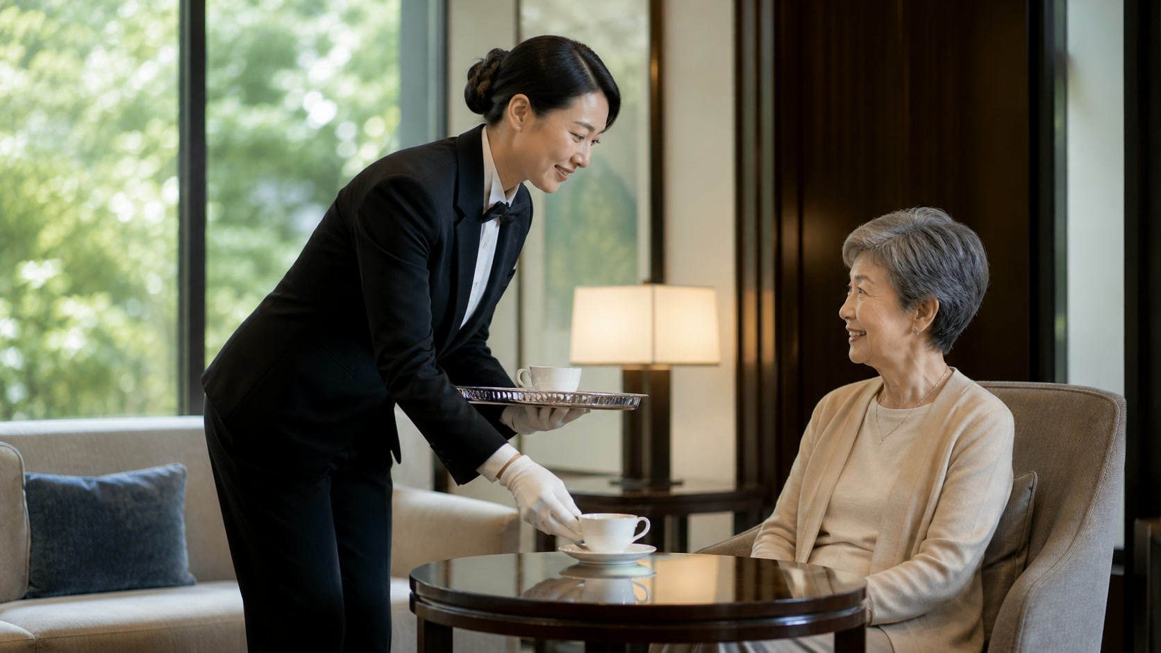 A modern Japanese butler serving tea indoors while carrying tradition into contemporary life